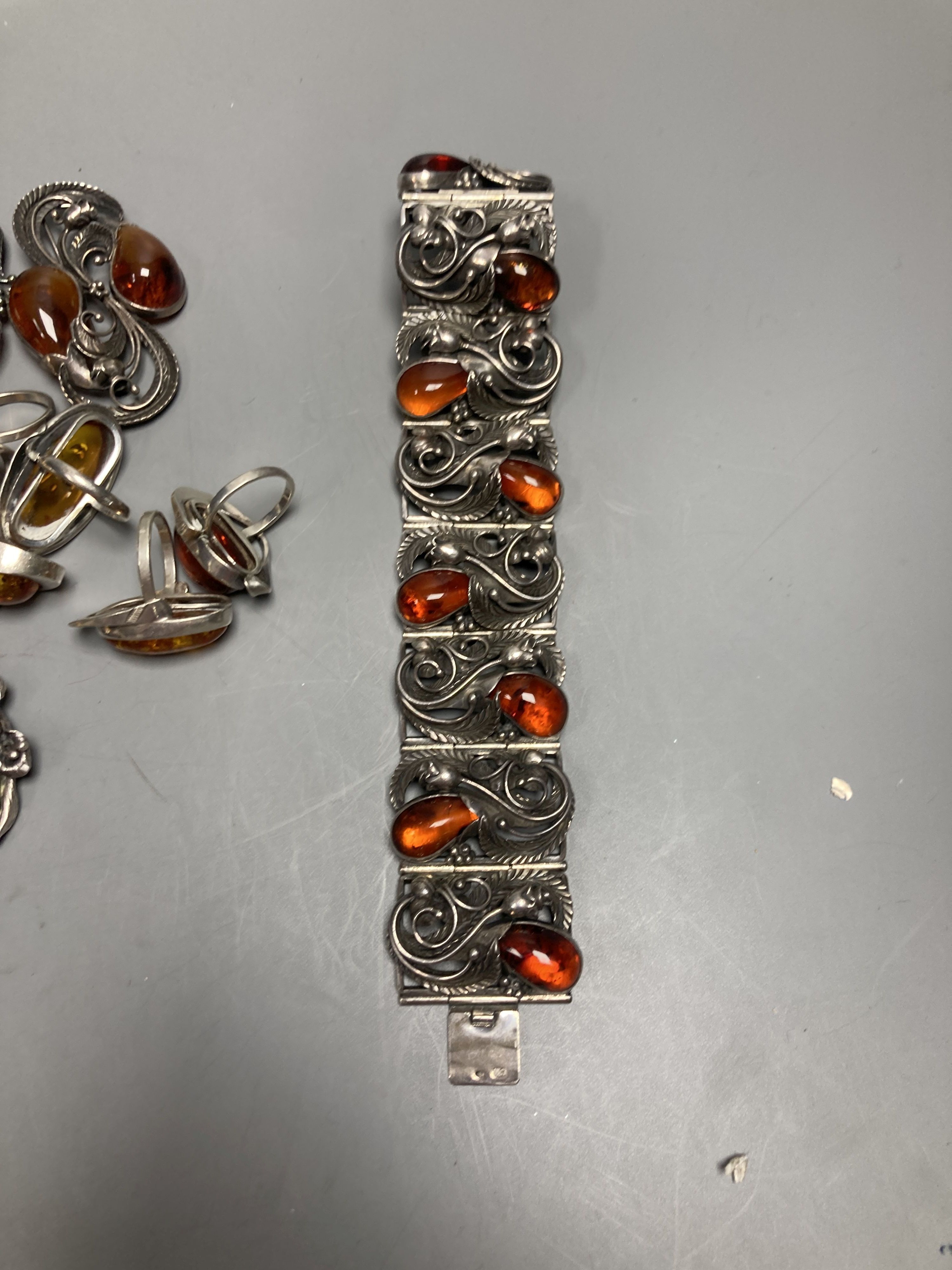 A mixed group of amber jewellery including white metal mounted bangle and Portuguese 925 bracelet.